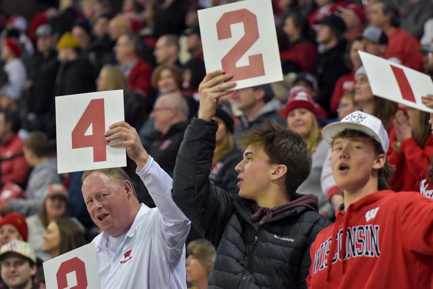 Wisconsin Badgers fans holding up number signs in the stands Wisconsin Badgers fans holding up number signs in the stands