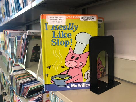 People in library borrowing books, browsing, reading 