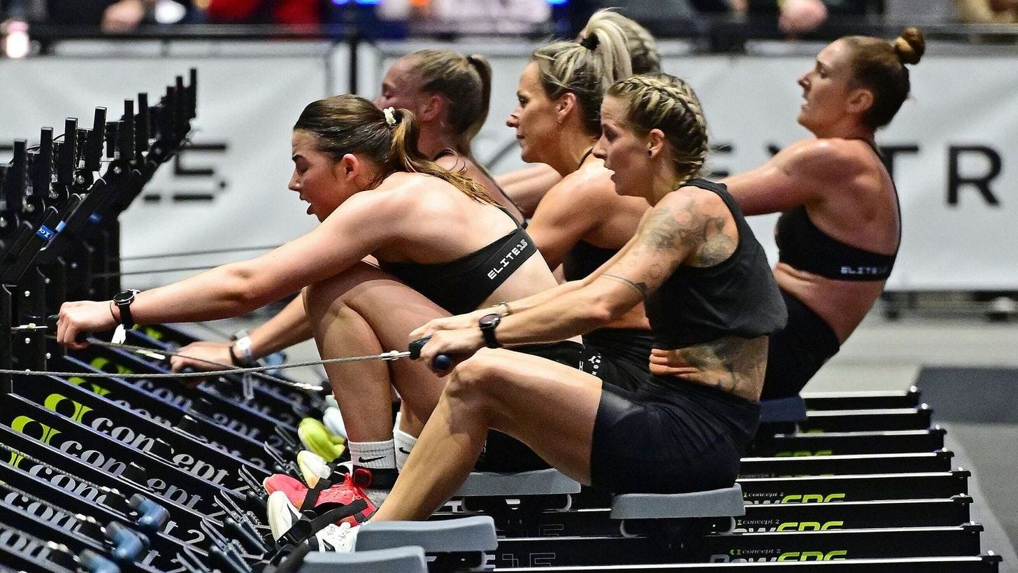 Athletes competing on rowing machines during a Hyrox race Athletes competing on rowing machines during a Hyrox race