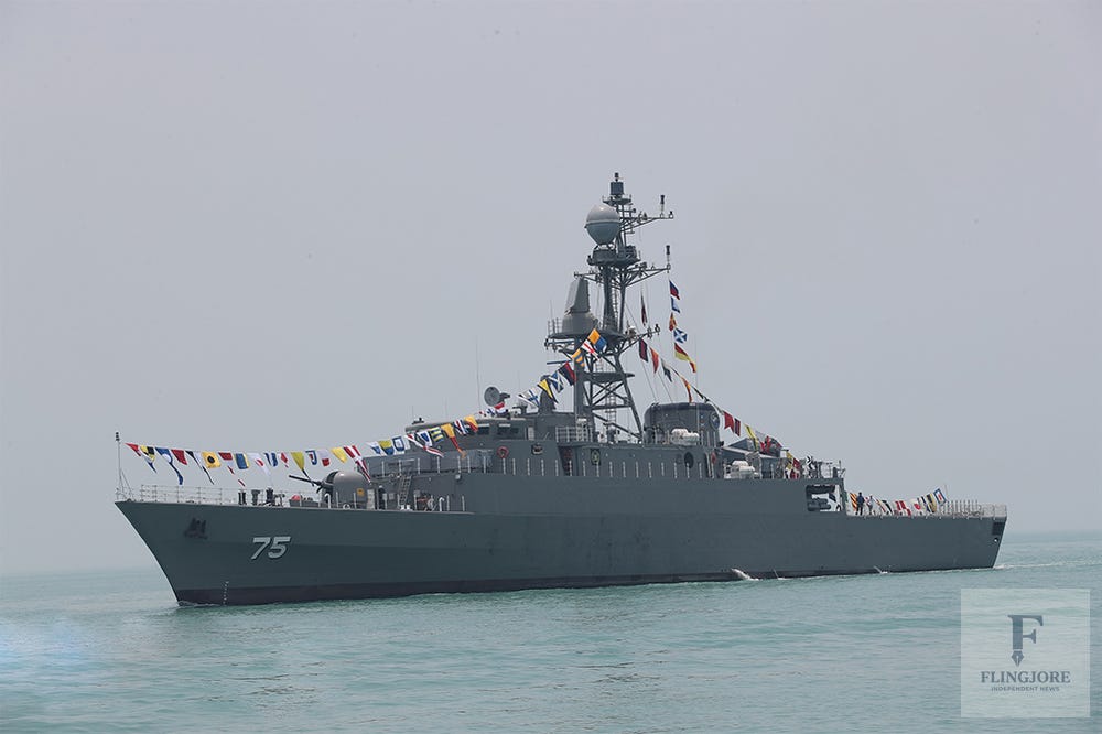 Side-profile view of the gray Iranian Navy Moudge-class frigate IRIS Dena navigating on open water.