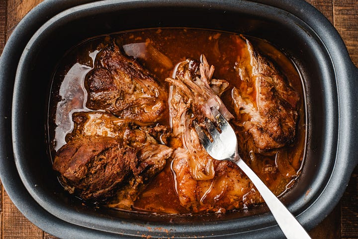 Left: Pork shoulder covered in seasonings and garlic in the slow cooker. Right: Slow cooked pulled pork with a fork pulling it apart.