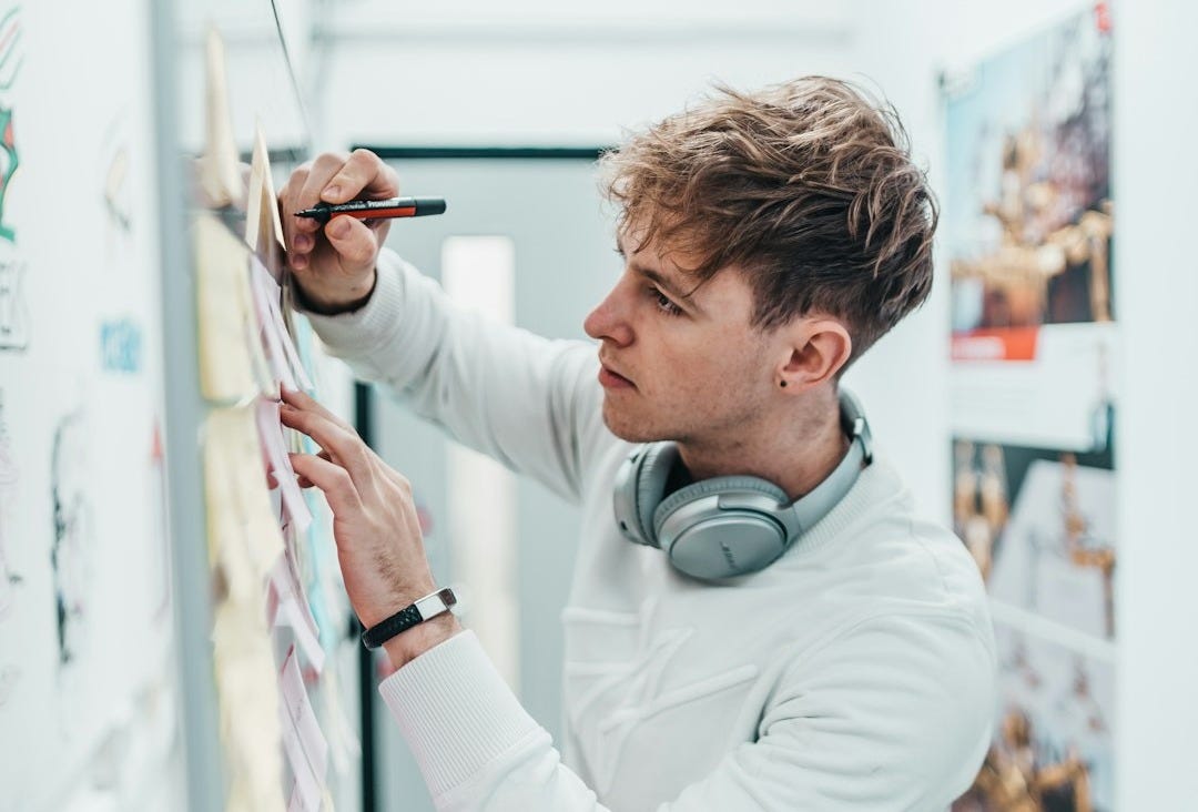 man with pen writing on wall man with pen writing on wall