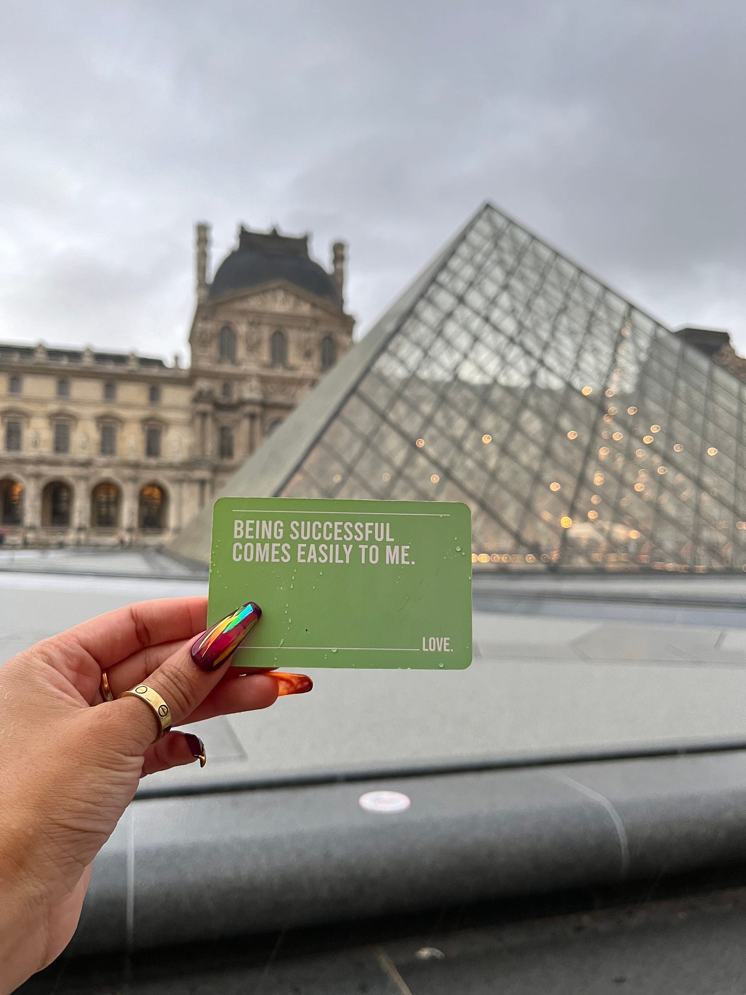 Being Successful Comes Easily to Me manifestation card in from of the Louvre pyramid