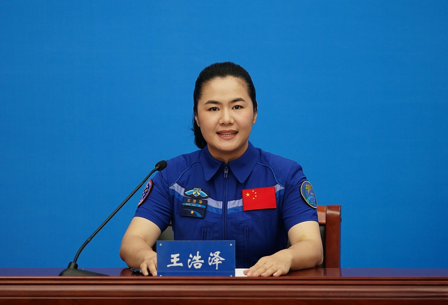 Shenzhou-19 Science Operator Wang Haoze speaks to the press.