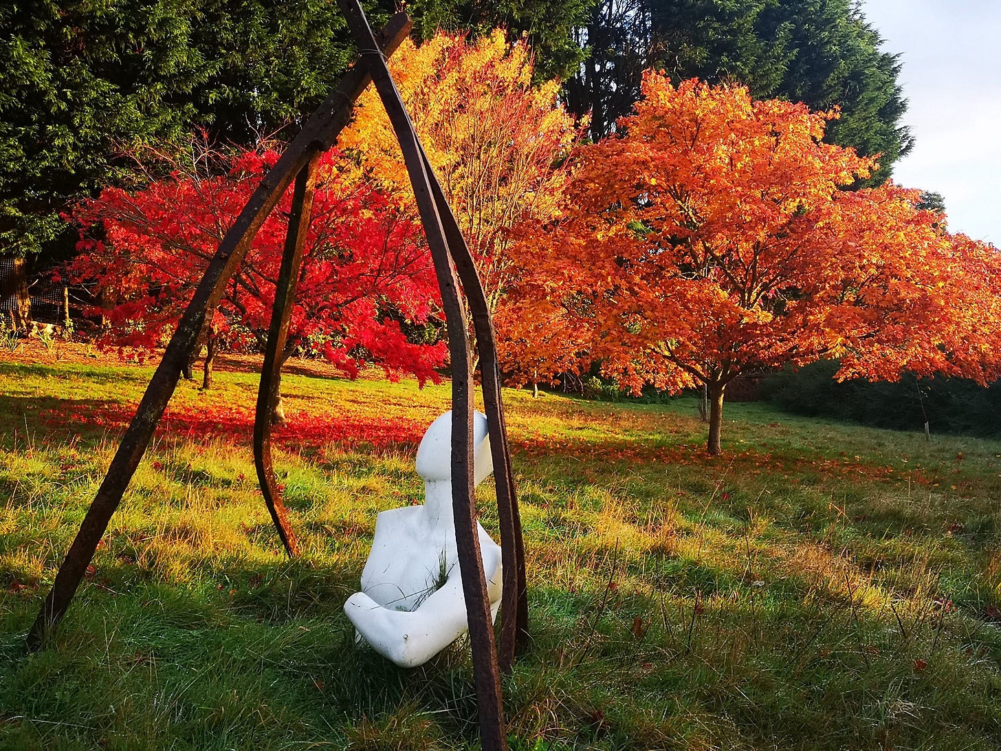 Sculpture and Vibrant Maple Tree Leaves in the Autumn Sculpture and Vibrant Maple Tree Leaves in the Autumn