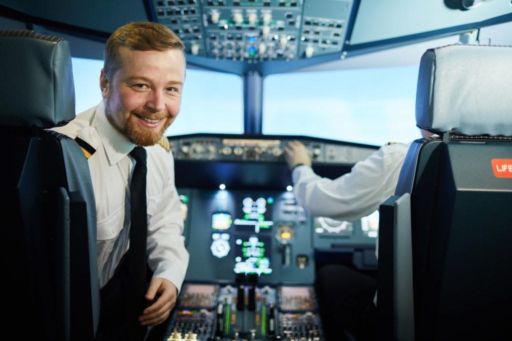Confident bearded pilot in cockpit Confident bearded pilot in cockpit