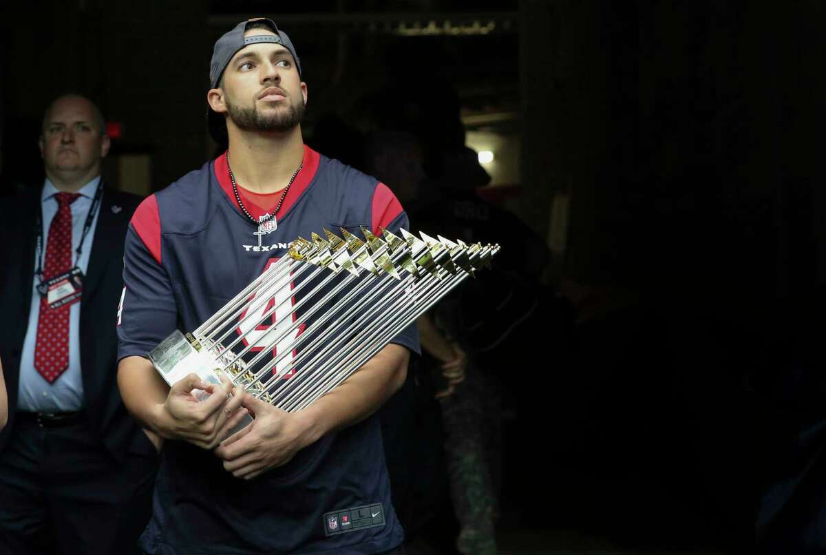 Houston Astros' George Springer bears the Wolrd Series Trophy and waiting in the tunnel to be recognized to the audience during the first quarter of an NFL football game between Houston Texans and Indianapolis Colts at NRG Stadium on Sunday, Nov. 5, 2017, in Houston.
