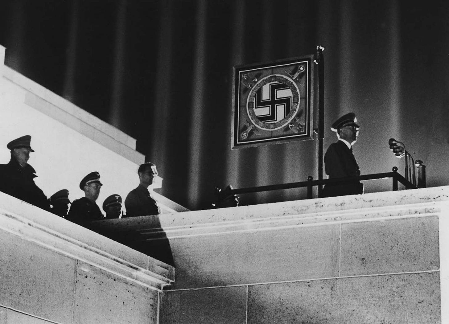 Hitler delivering an impassioned speech at the Nuremberg rallies, illuminated by the Cathedral of Light, 1937. Hitler delivering an impassioned speech at the Nuremberg rallies, illuminated by the Cathedral of Light, 1937.
