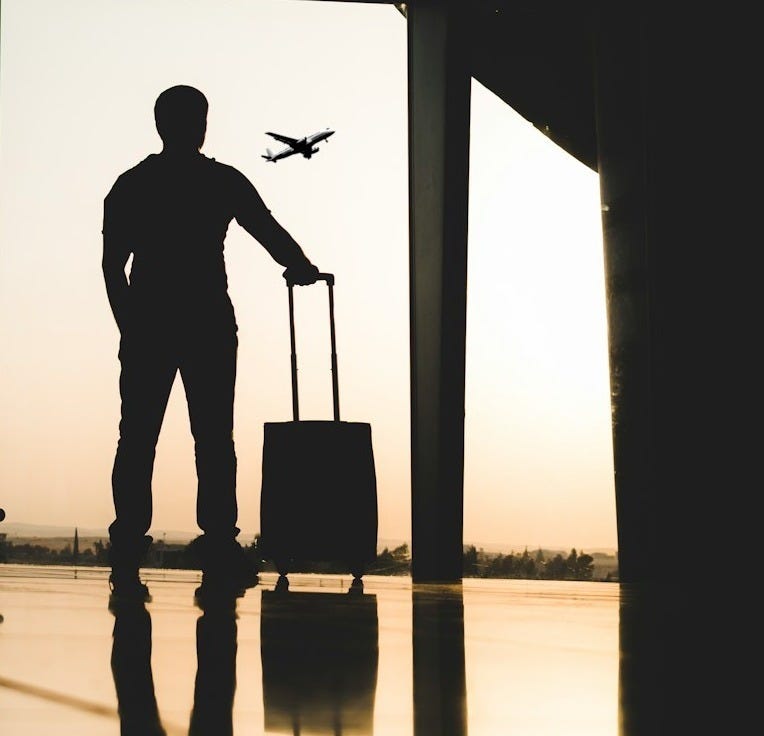 silhouette of man holding luggage inside airport silhouette of man holding luggage inside airport