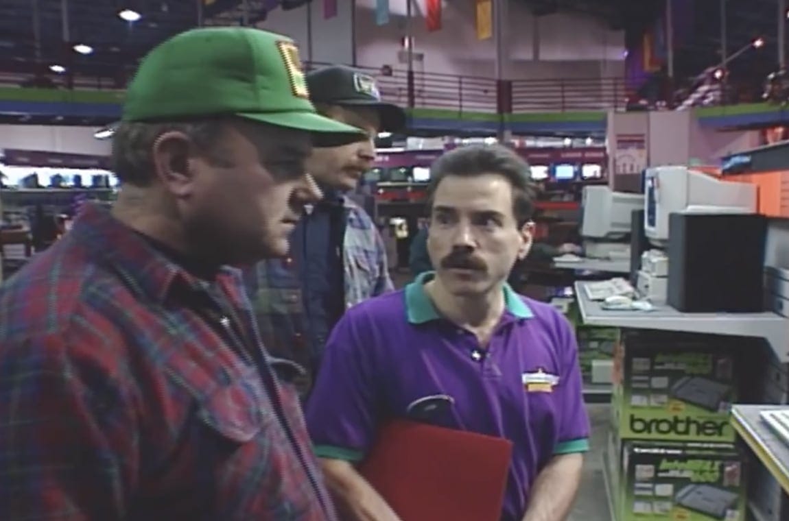 Two customers talking to a computer sales associate in 1994