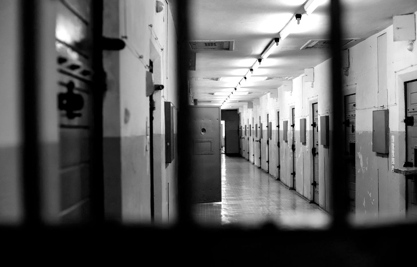 a long hallway with a bunch of lockers in it a long hallway with a bunch of lockers in it