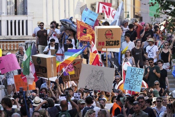 Activists stage a protest in Venice, Italy, Saturday, June 28, 2025, denouncing the three-day celebrations for the wedding between Jeff Bezos and his wife Lauren Sanchez Bezos that took place in Venice on Friday as a symbol of rising inequality and disregard for the city's residents. (AP Photo/Antonio Calanni)