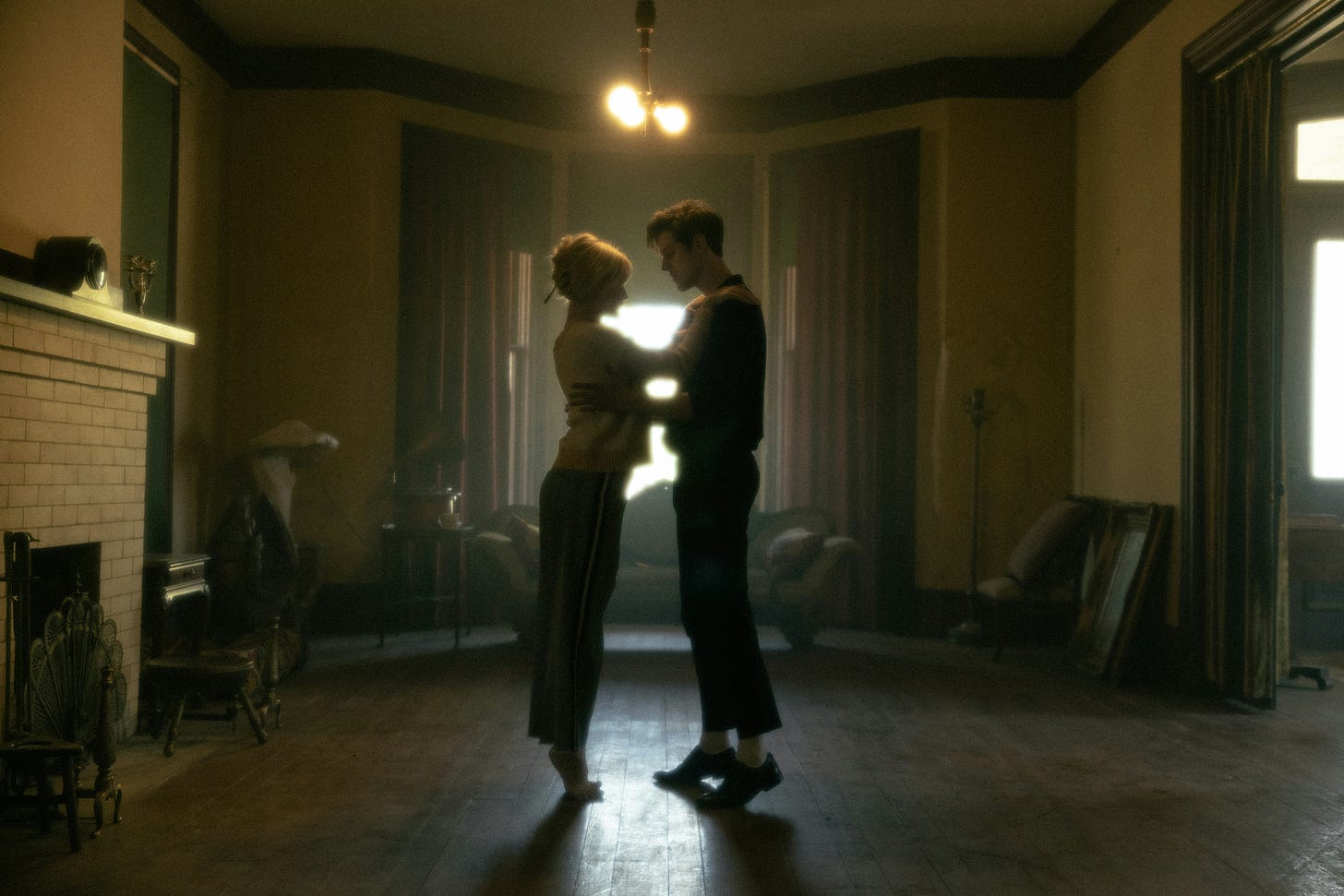 A man and a woman in a dance position, standing in a dimly lit room. Photo by Jakob Owens on Unsplash.