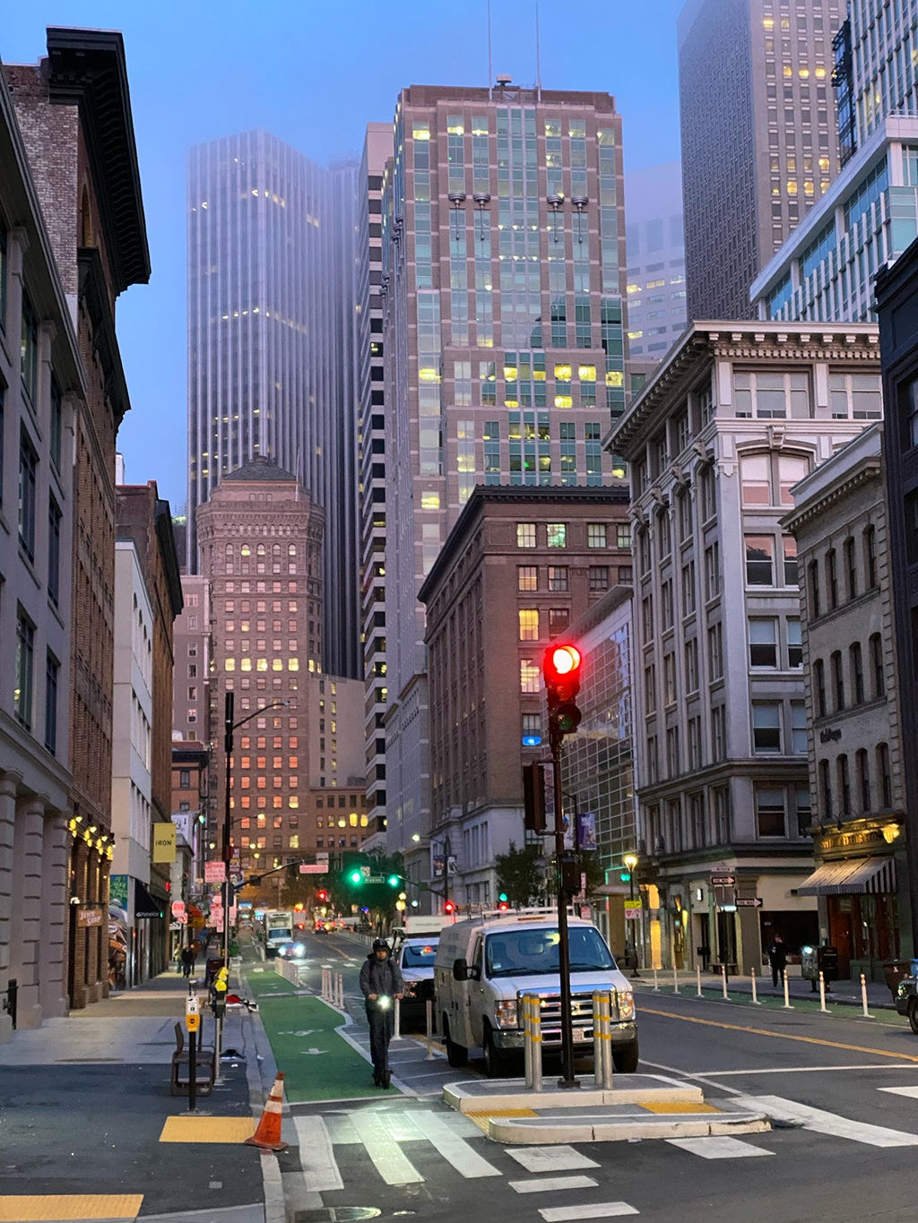 Dawn breaks over the city, as I walk to a cafe.