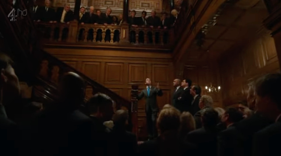 A person in a suit standing in front of a crowd of people

AI-generated content may be incorrect.