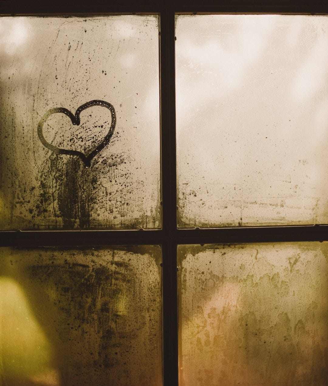 black framed glass window with heart draw