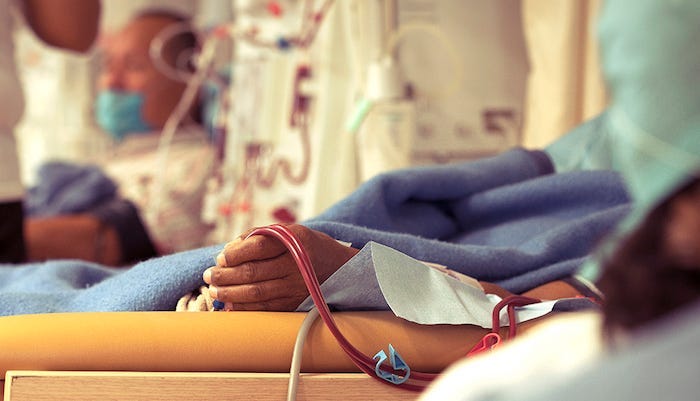 Kidney donors recovering in hospital beds. Kidney donors recovering in hospital beds.