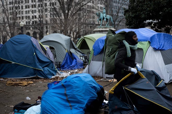 A man packs a tent before members of the National Park Service clear a homeless encampment from McPherson Square, two blocks from the White House, on Feb. 15, 2023 in Washington, DC.