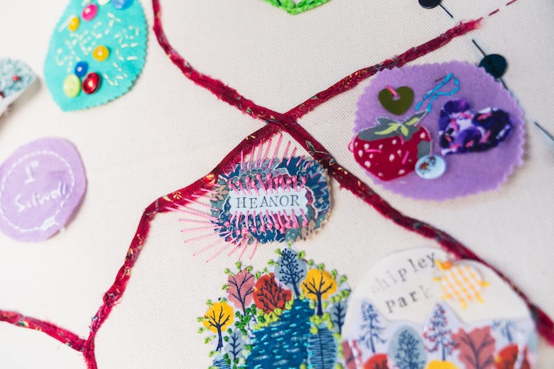 Colourful embroidery of different shapes with the word Heanor in the centre