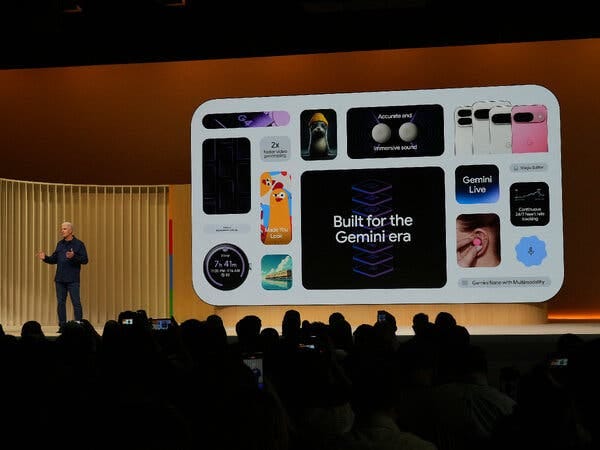 A man talking on a stage next to a screen showing an image saying “Built for the Gemini era.” A man talking on a stage next to a screen showing an image saying “Built for the Gemini era.”