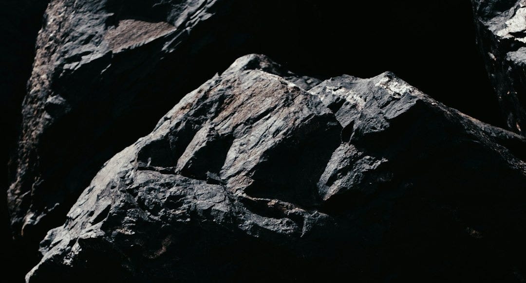 a close up of rocks with a black background a close up of rocks with a black background