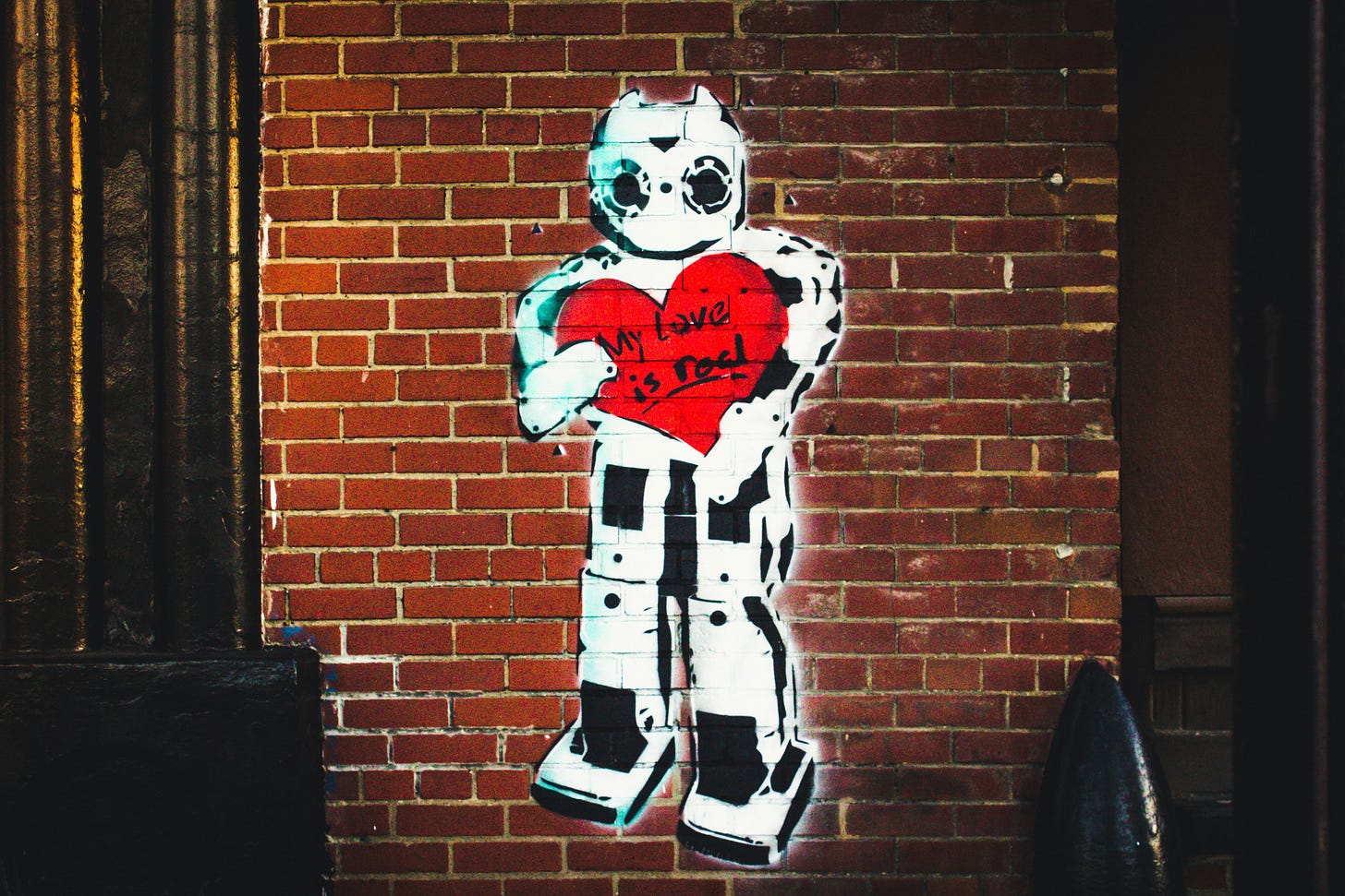 white-robot-painted-brick-wall