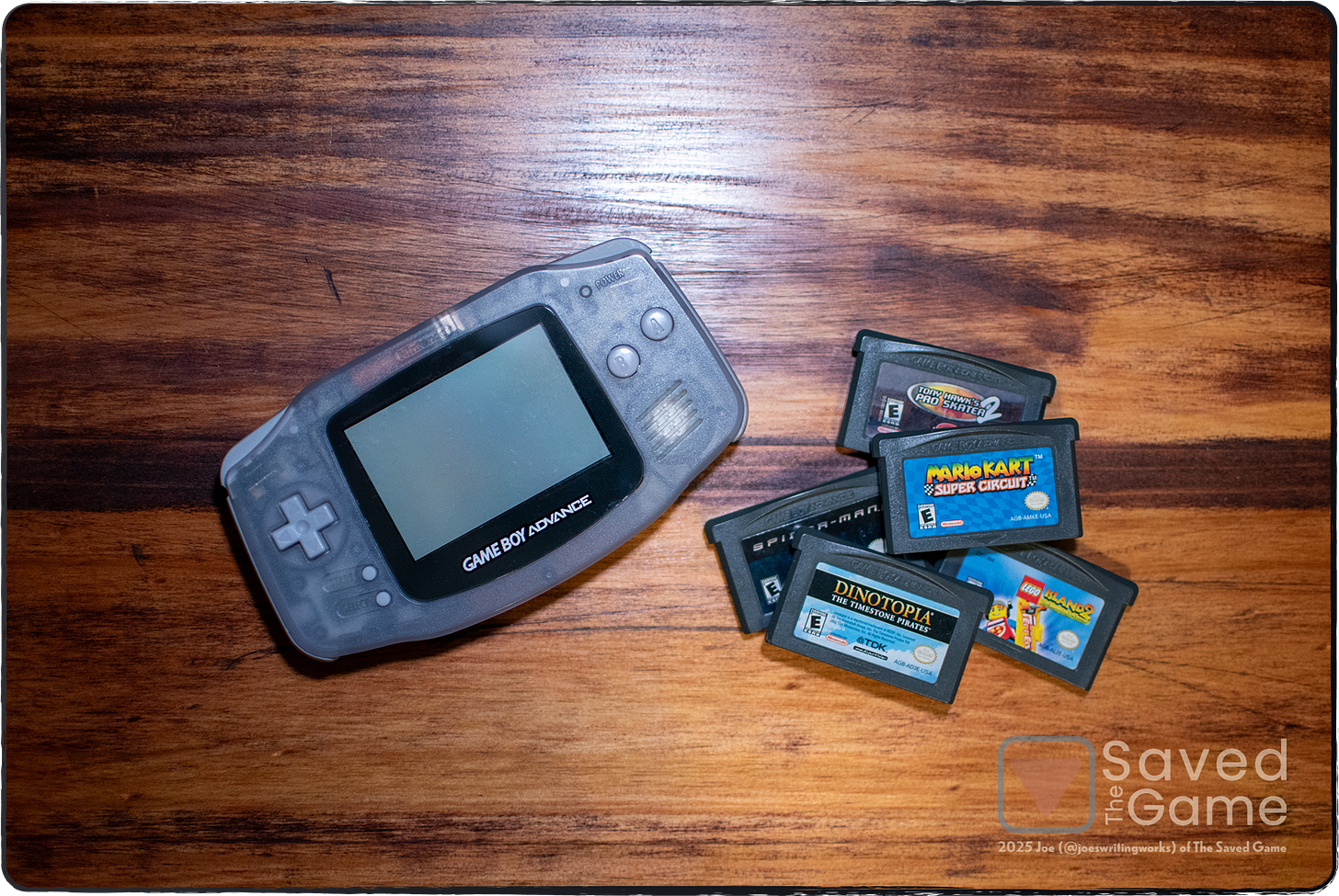 An image show a game boy advance with a pile of games!