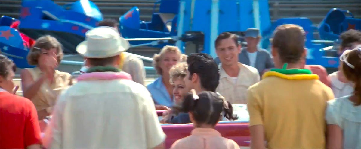 Sandy and Danny in the Ford pass through the excited crowd at the end of 1978 film Grease