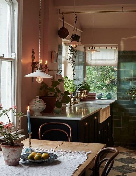 Devol Kitchens with pink walls and brass poles.