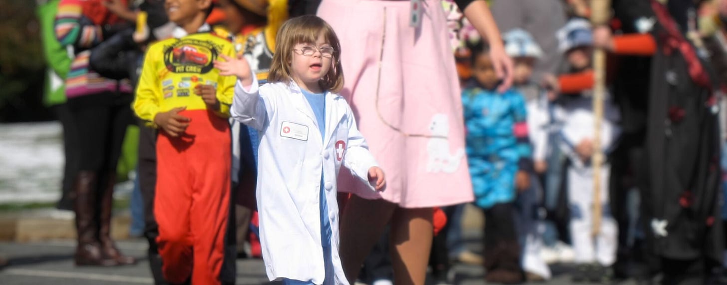 young Penny marches in a Halloween parade