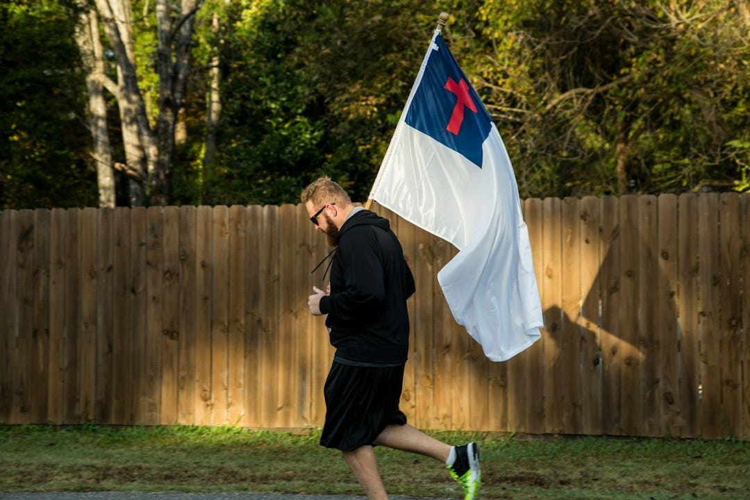 man in black jacket holding flag man in black jacket holding flag