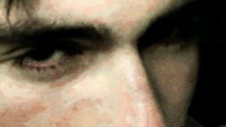 This may contain: a close up of a man's face with his eyes wide open