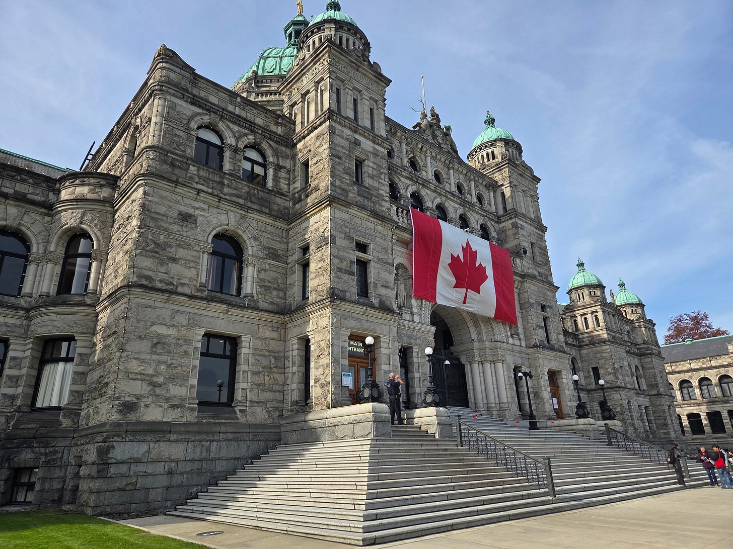 A picture of the BC Legislature building, with a prominent Canadian flag hanging over the steps.