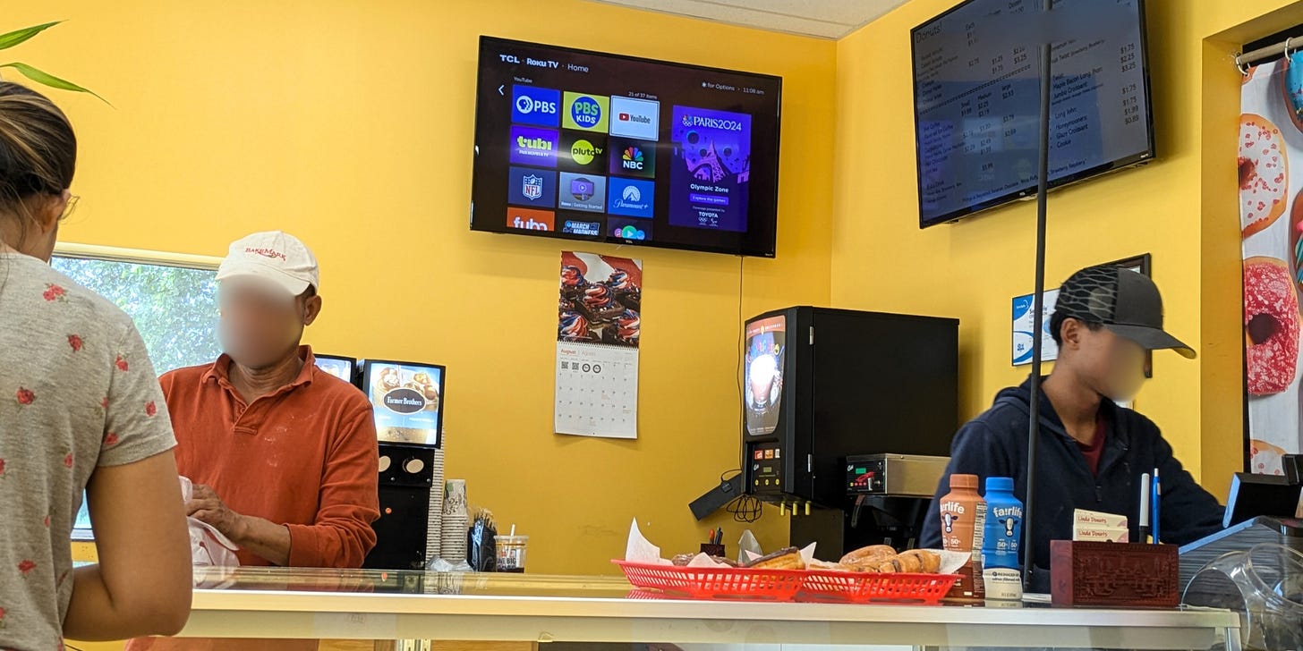 Two men working behind the counter at Linda Donuts Two men working behind the counter at Linda Donuts