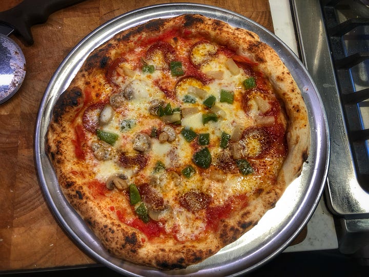 Two photos of pizzas with pepperoni, green onion, mushroom, and pineapple on a metal tray. The pizza on the left is small and misshapen with a thick, doughy crust. The pizza on the right covers almost the entire tray and has a much more proportional crust.