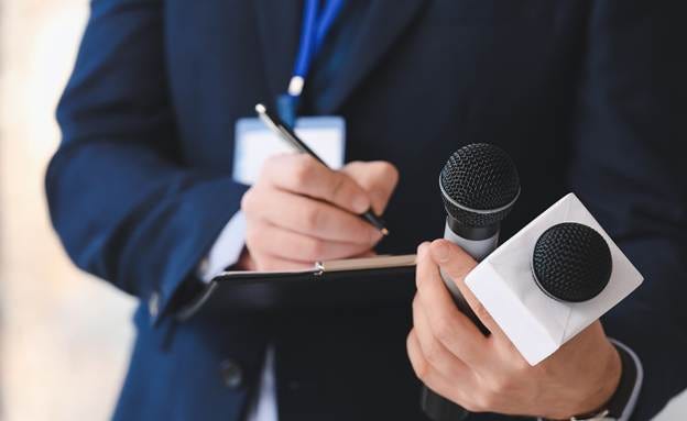 A person holding a microphone and a clipboard

AI-generated content may be incorrect.