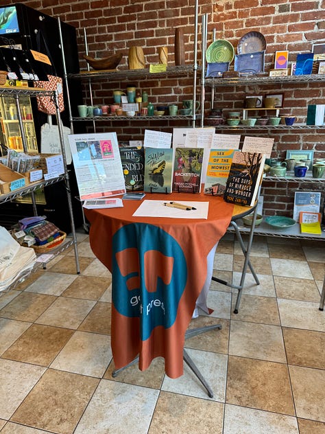 Images of Galiot Press books displayed on a table inside a café