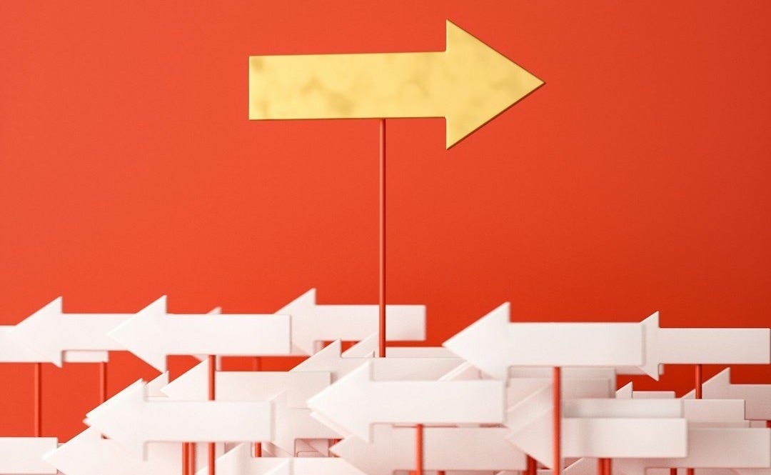 a red wall with a yellow arrow pointing in opposite directions a red wall with a yellow arrow pointing in opposite directions