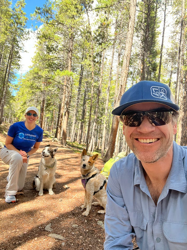 A woman, a man and two dogs hiking in Colorado