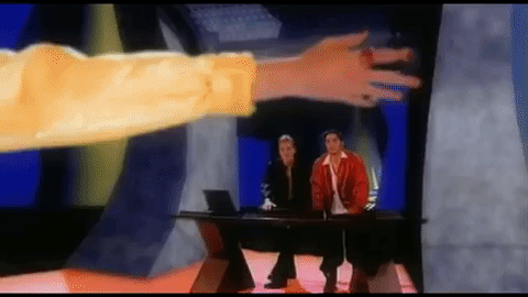 We can see the blonde woman's arm fading out into pieces again; Lance and Chris are at the desk and Chris gives an "oops" shrug.