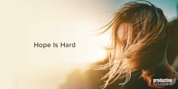 Woman in the sun, with hair blowing in her face. Text overlay: Hope Is Hard Woman in the sun, with hair blowing in her face. Text overlay: Hope Is Hard