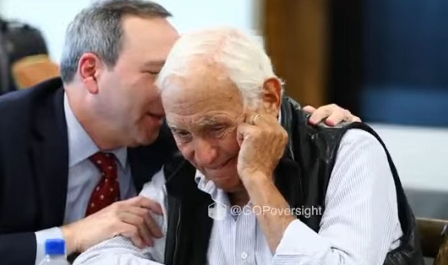 Two men share a moment of connection, with one whispering to the other, who appears emotional and reflective in a casual setting. Two men share a moment of connection, with one whispering to the other, who appears emotional and reflective in a casual setting.