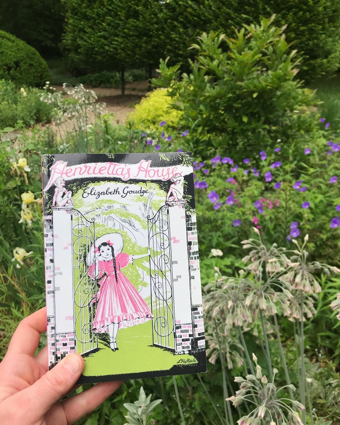 My paperback copy of Henrietta’s House in my cottage garden at my own house of dreams. My paperback copy of Henrietta’s House in my cottage garden at my own house of dreams.