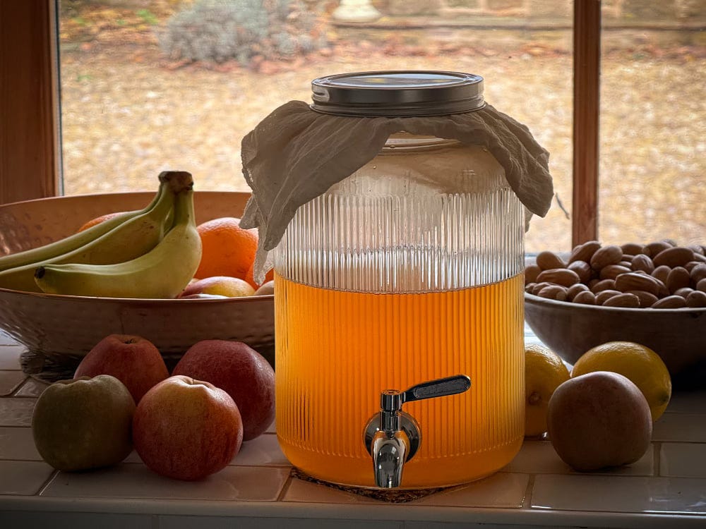 A big jar containing an orange liquid