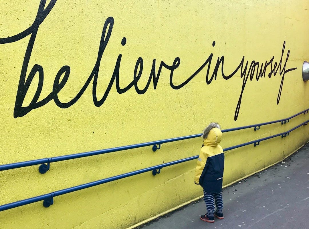 toddler looking at believe in yourself graffiti toddler looking at believe in yourself graffiti
