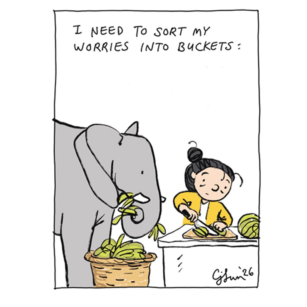 Panel 1 of 7 of a 2-page comic strip about managing worries, illustrating a cartoon girl with a bun talking to an elephant and preparing food. To get through the day, she has to separate her stresses and worries into different buckets. Titled "Different Buckets," original artwork by Connie Sun, cartoonconnie, 2026.