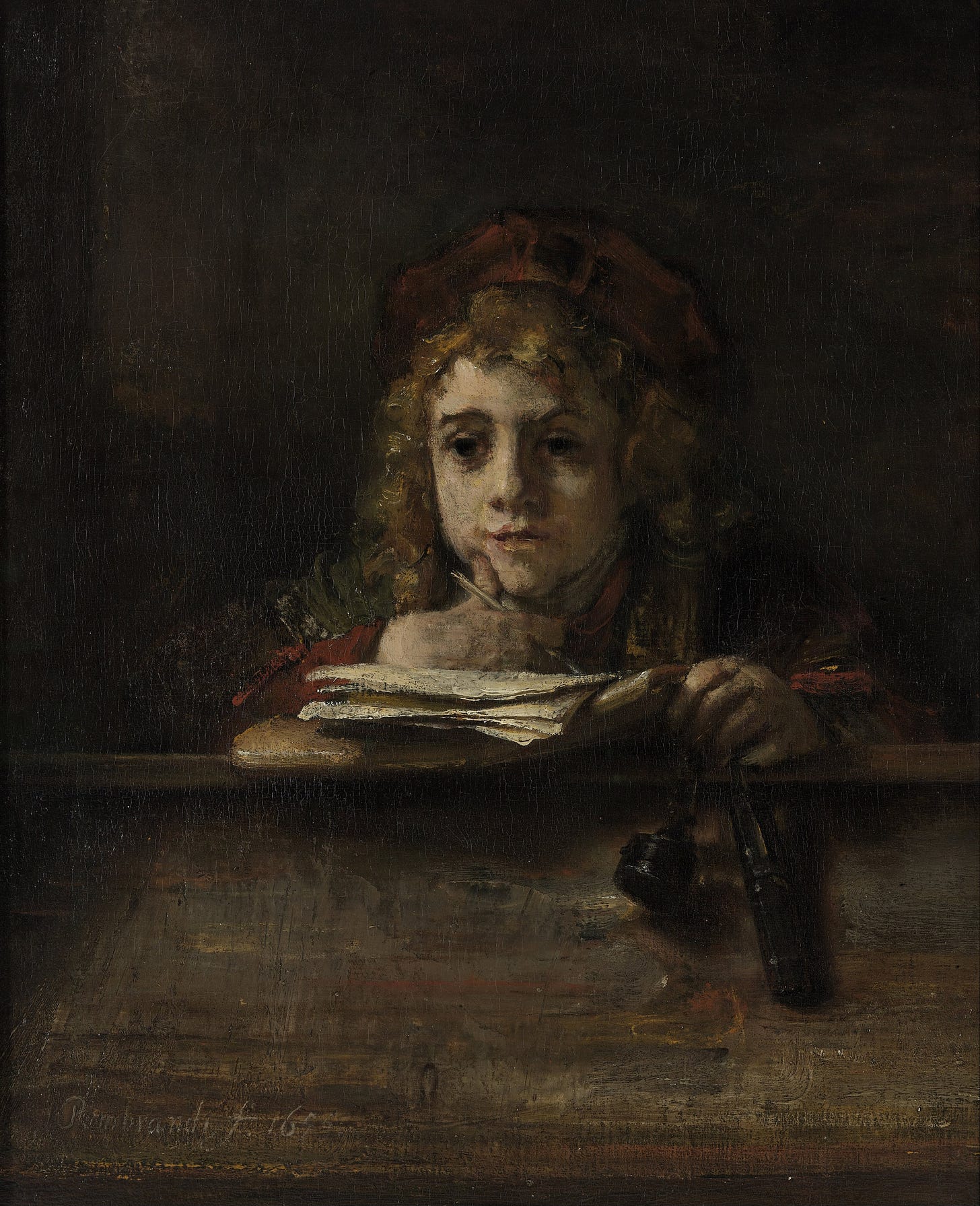 Boy daydreaming at a school desk Boy daydreaming at a school desk