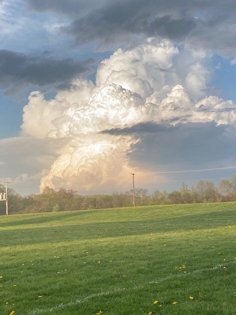 A multi-layered cloud across a field