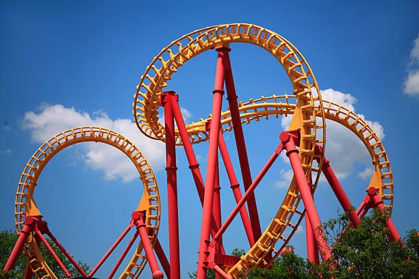 A roller coaster track with blue sky

Description automatically generated