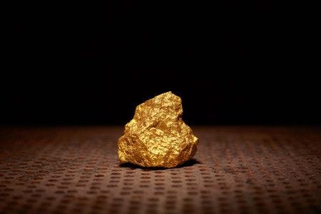 Close up of big gold nugget finance and business concept gold ore found in the mine trade and exchange Close up of big gold nugget finance and business concept gold ore found in the mine trade and exchange